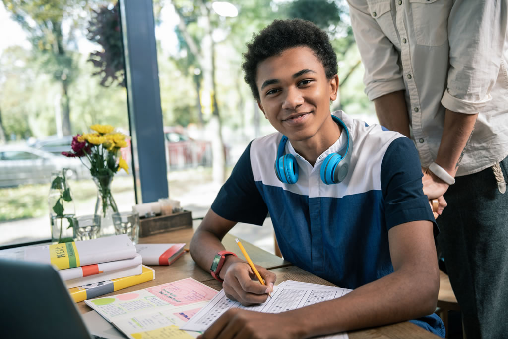 Working on tasks. Smart student. Clever pupil. Tasks photo.